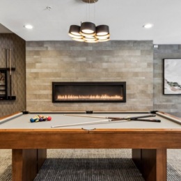 a room with a pool table and a fireplace