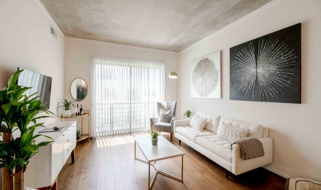 a living room with a couch, tables and a tv