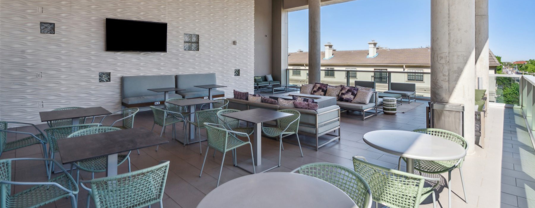 a patio with tables and chairs