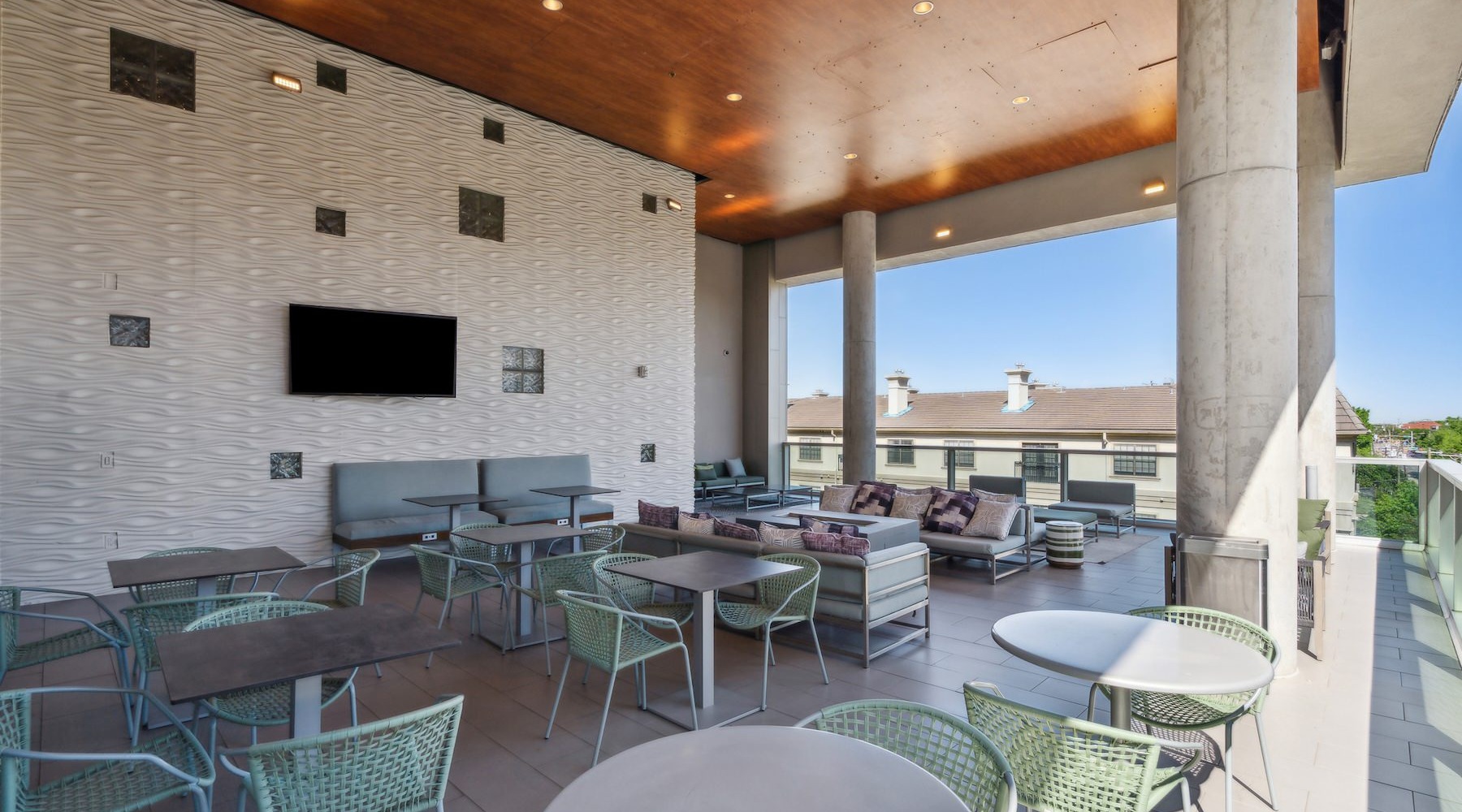 a patio with tables and chairs