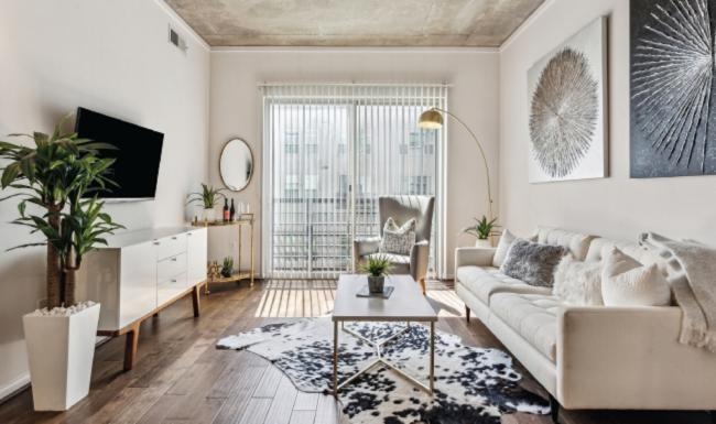 a living room with a couch, tables and a tv