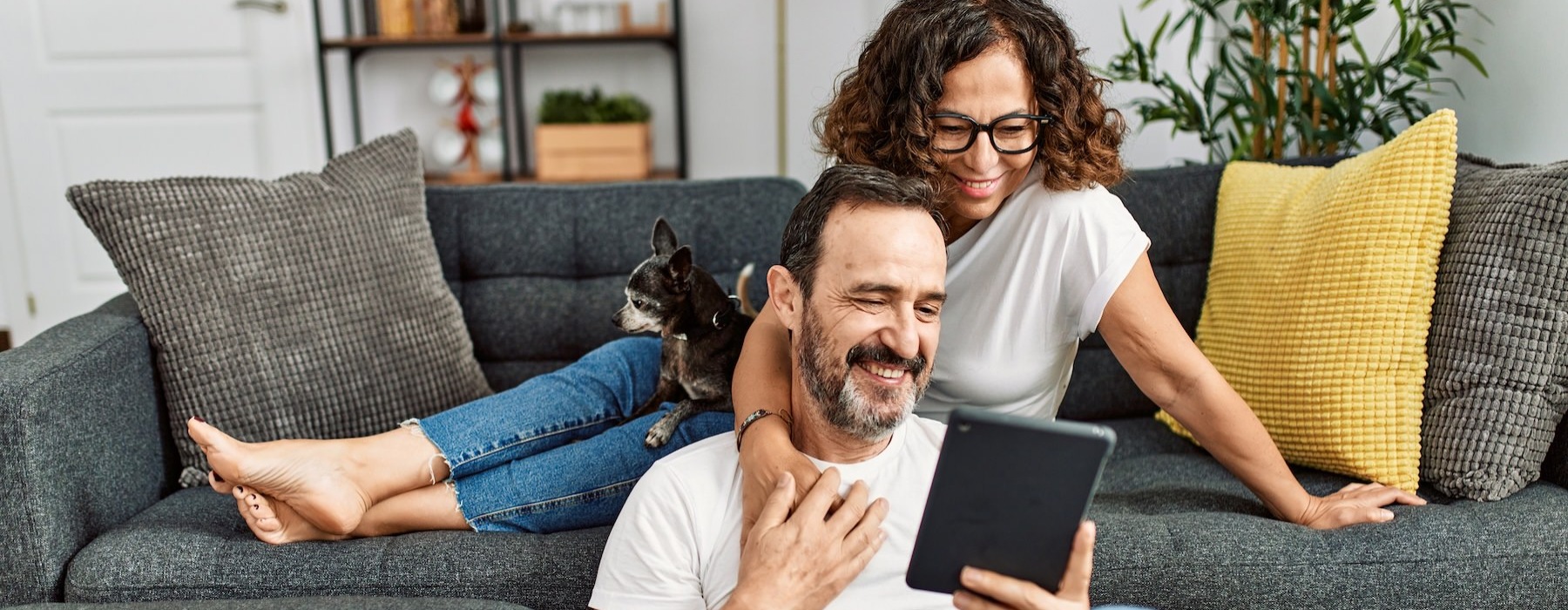 a man and a woman looking at a tablet