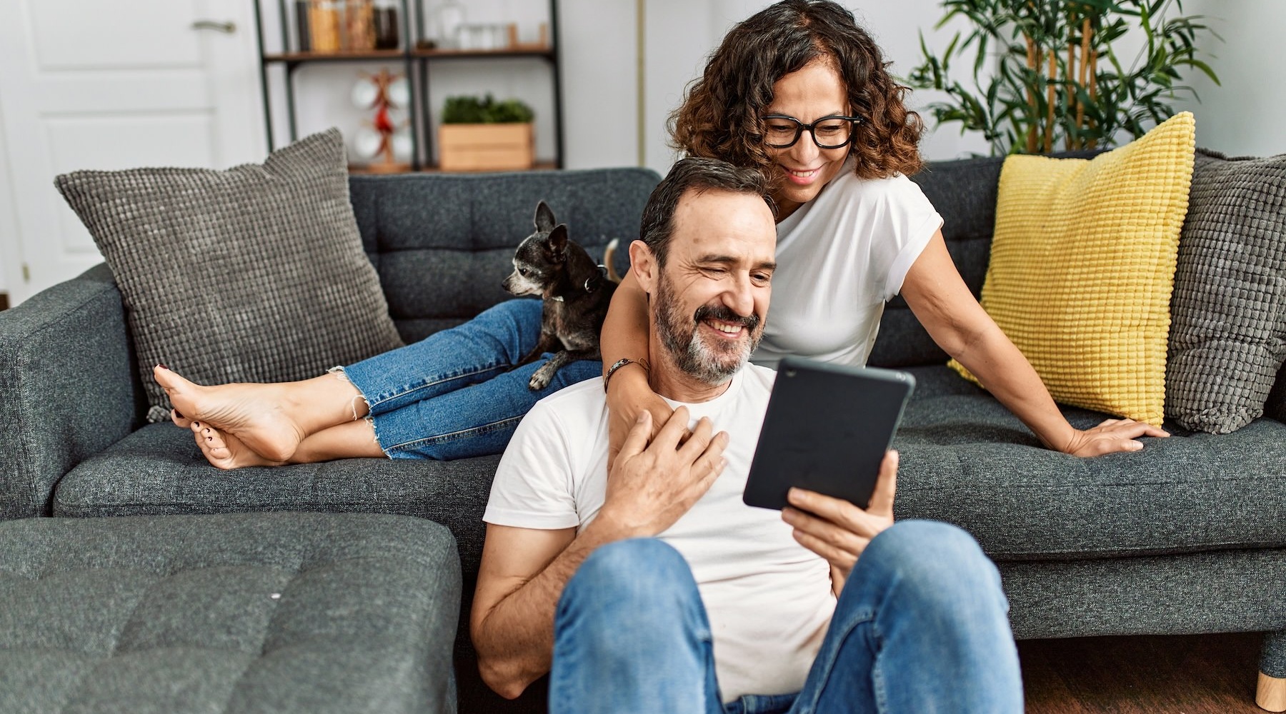 a man and a woman looking at a tablet